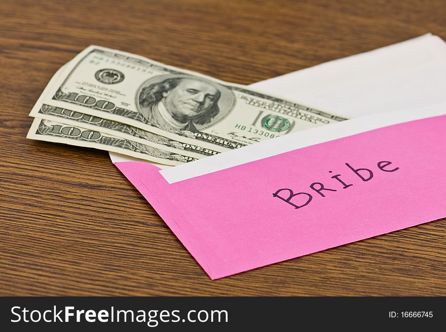 Pink envelope with money on wood table. Pink envelope with money on wood table