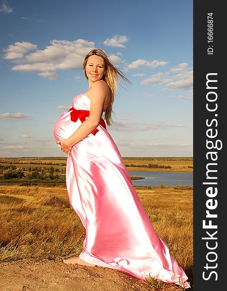 Beautiful, happy pregnant girl in nature. Beautiful, happy pregnant girl in nature