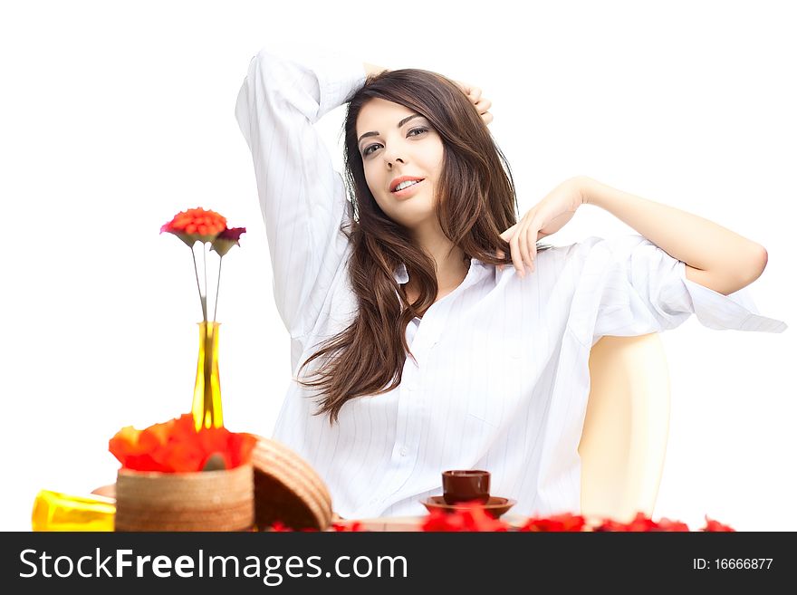 Beautiful woman  in cafe over white background with red  flowers