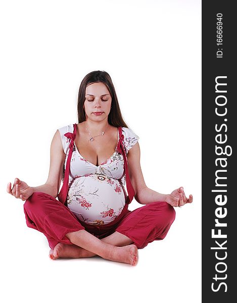 Pregnant woman in the studio on a white background