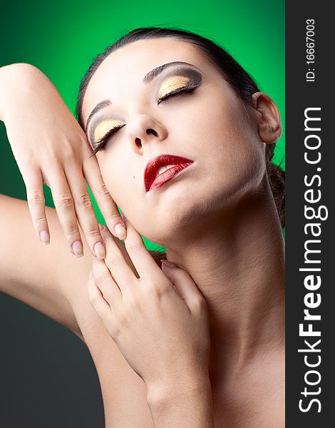 Beautiful woman over color  background with beautiful makeup. Beautiful woman over color  background with beautiful makeup