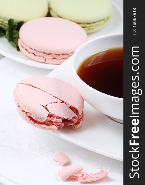 Cup of coffee and macaroon on a white background