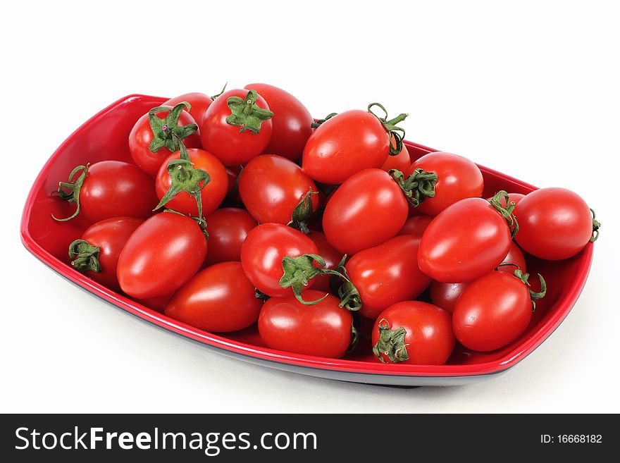 Red Tomatoes on plate on white background