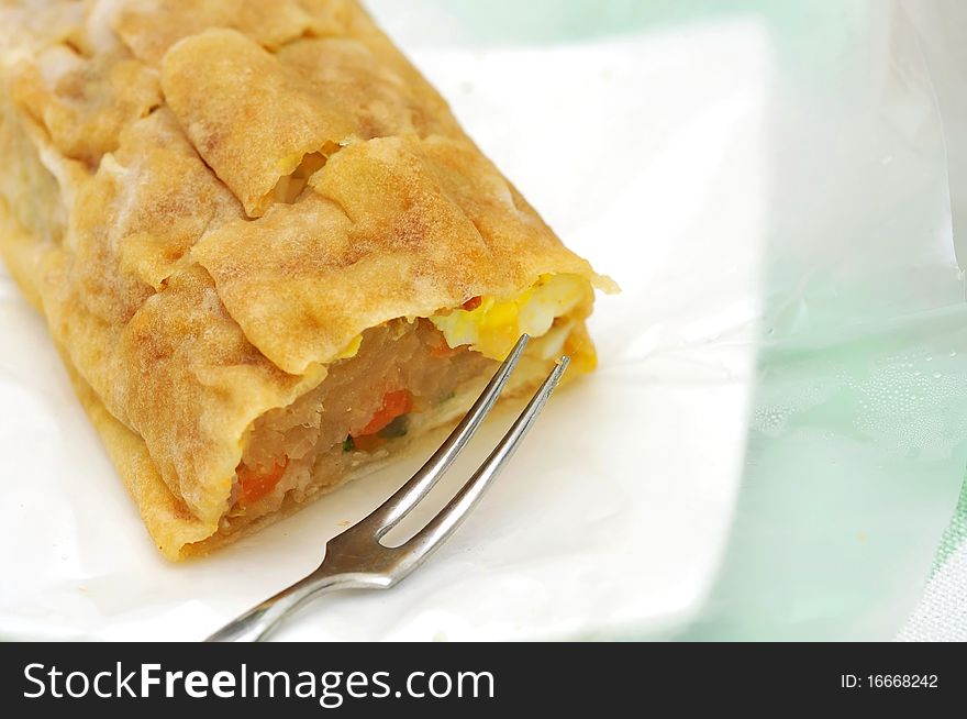 Asian style traditional spring roll or crepe made from flour with fillings including various mixed vegetables. Asian style traditional spring roll or crepe made from flour with fillings including various mixed vegetables.