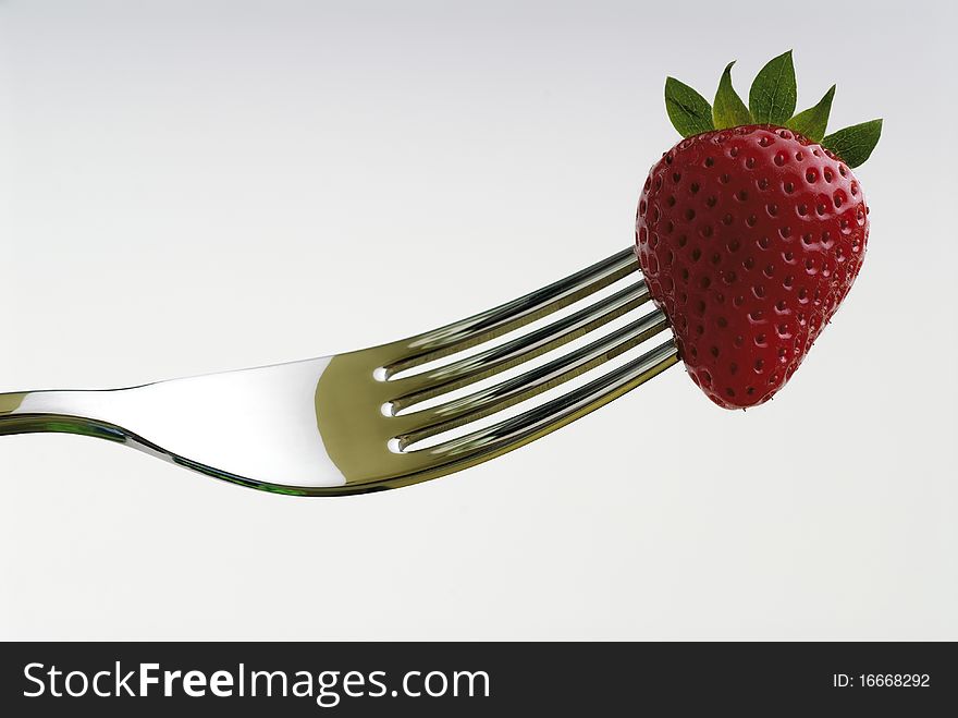 Strawberry skewered by a fork