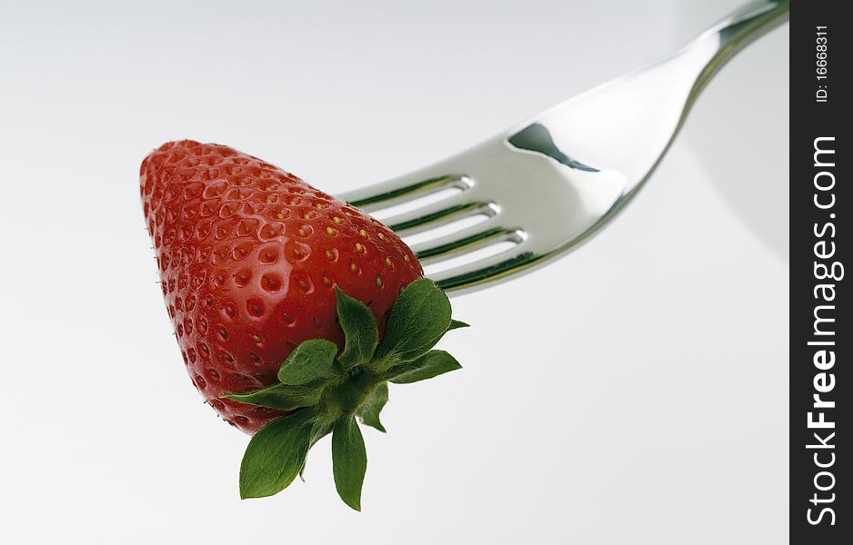 Strawberry skewered by a fork