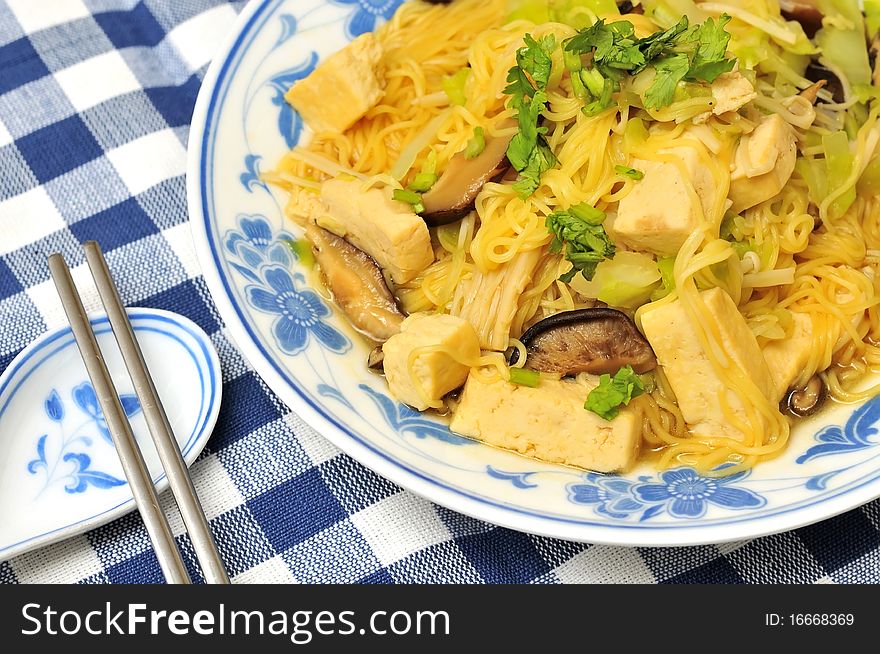 Closeup of delicious Chinese noodles cooked with healthy vegetables.