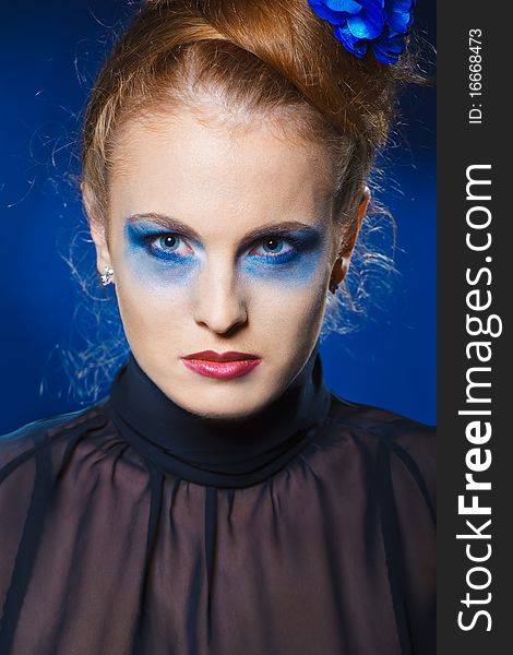 Closeup portrait of a serious lady with smoky eye makeup