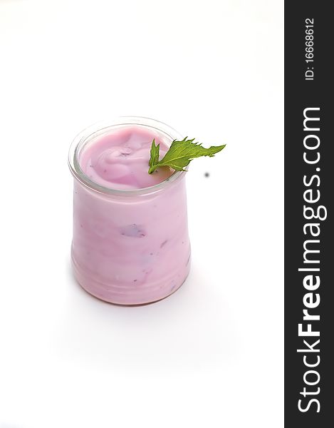 Bowl of blueberry yoghurt on white background