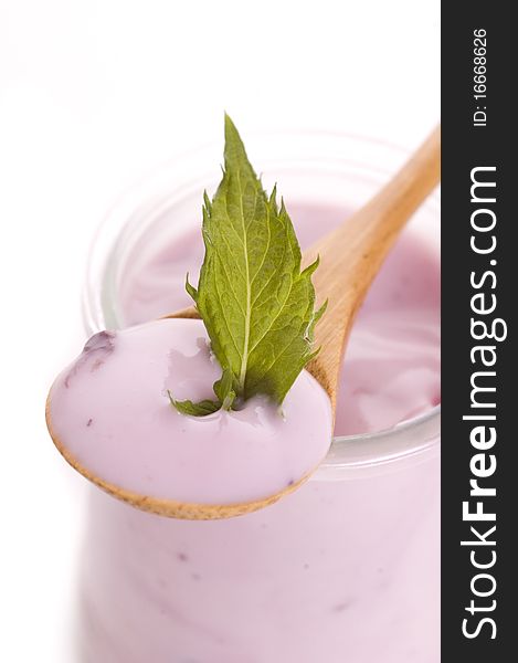 Bowl of blueberry yoghurt on white background