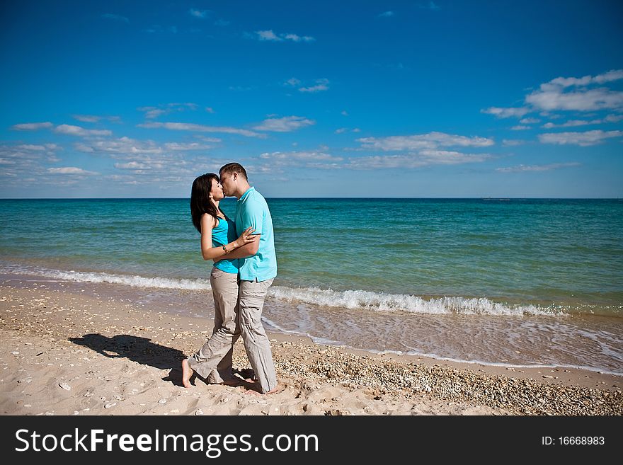 A couple on beach kissing