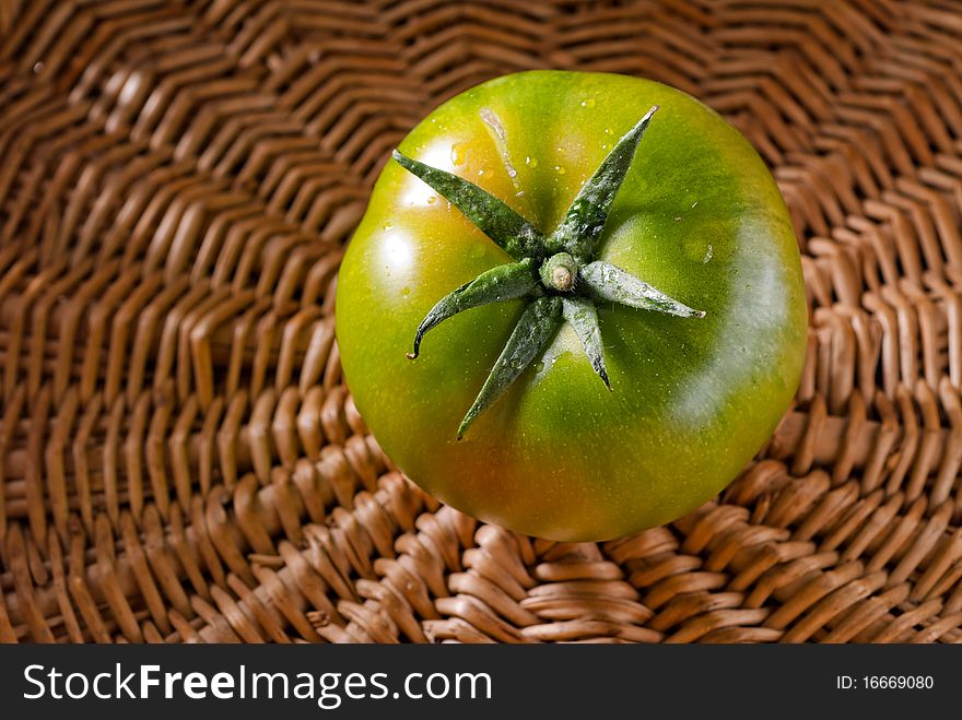 Green tomato in a wicker basket