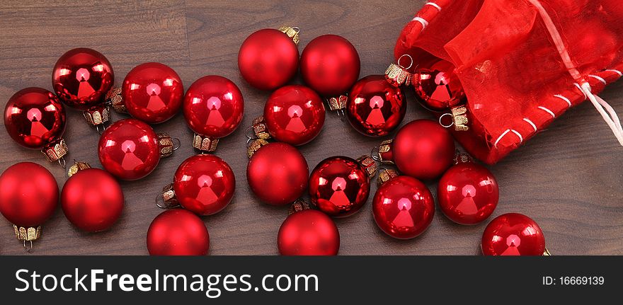 Some red christmas-balls are laying on the floor. Some red christmas-balls are laying on the floor