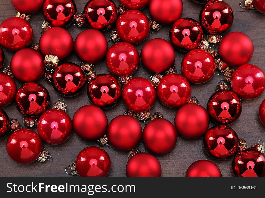 Some red christmas-balls are laying on the floor. Some red christmas-balls are laying on the floor