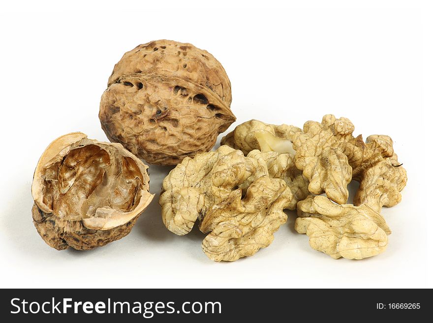 Peeling walnuts on white background