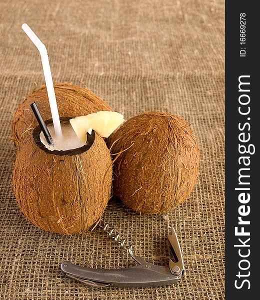 Coconuts with cocktail inside of one