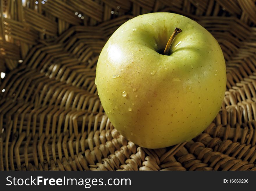 Green apples in a wicker basket