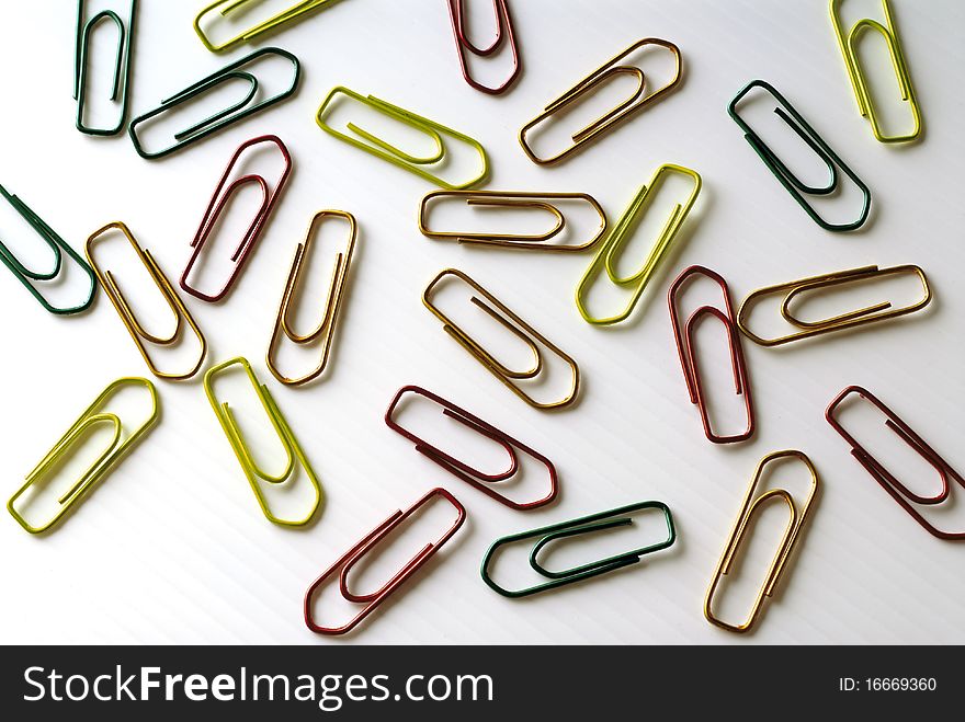 Colorful paper clips on a white surface