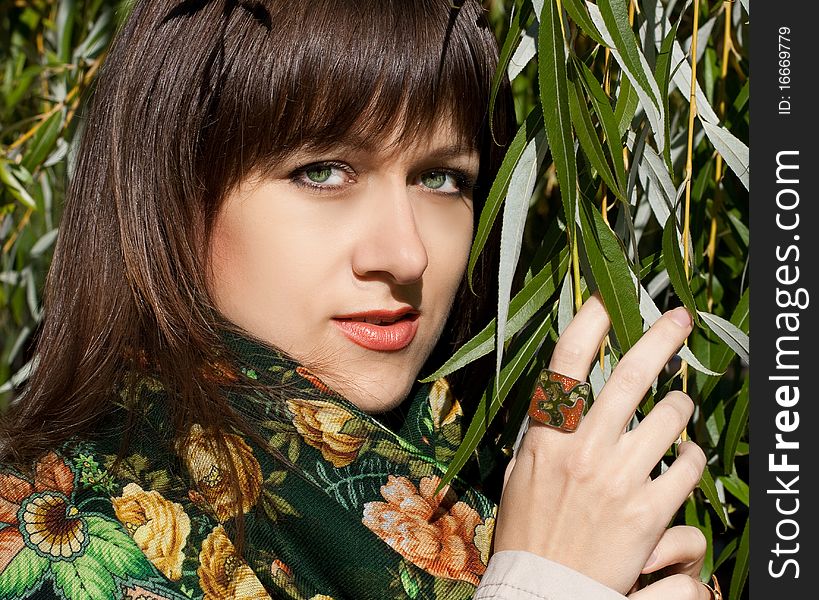 Portrait of beauty young woman with leaves of the tree