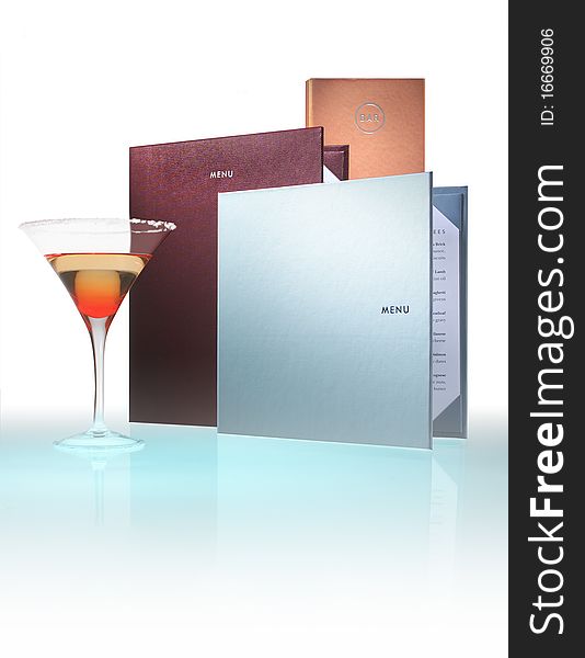 Menus on reflective white with cocktail glass alongside. Menus on reflective white with cocktail glass alongside