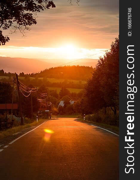 Colorful sunset over the mountains, street view