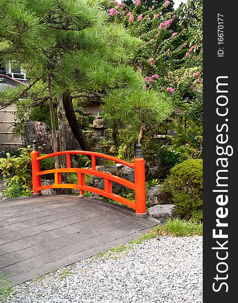 A shot of a traditional Japanese red stone bridge. A shot of a traditional Japanese red stone bridge