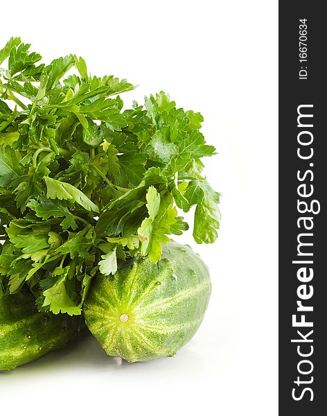 Cucumbers and parsley on a white background