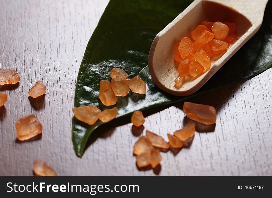 Spa setting with orange salt on the wooden background