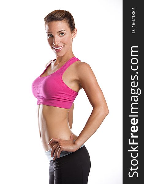 A thin athletic woman wearing workout gear smiling and posing. A thin athletic woman wearing workout gear smiling and posing