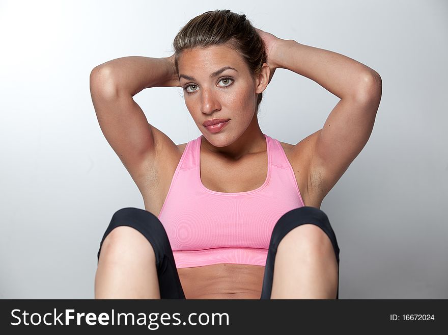 An attractive young woman doing situps