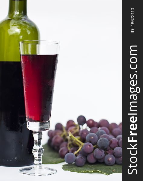 Red wine and grapes isolated in white