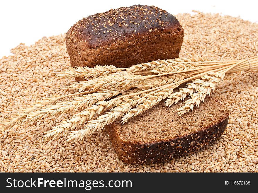 Bread with wheat and ears on white