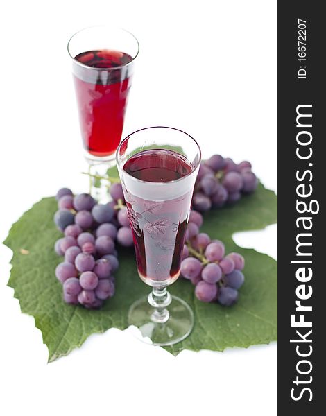 Red wine and grapes isolated in white