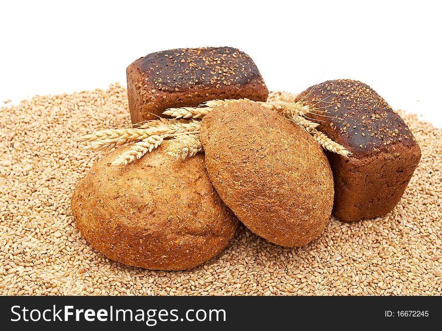 Bread with wheat and ears on white