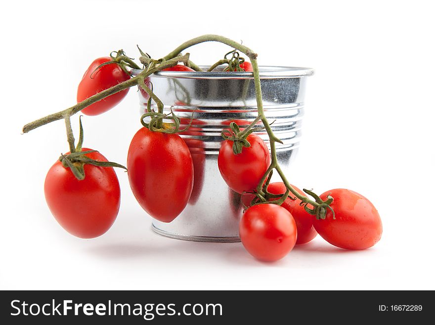 Branch of fresh cherry tomatoes on the white background