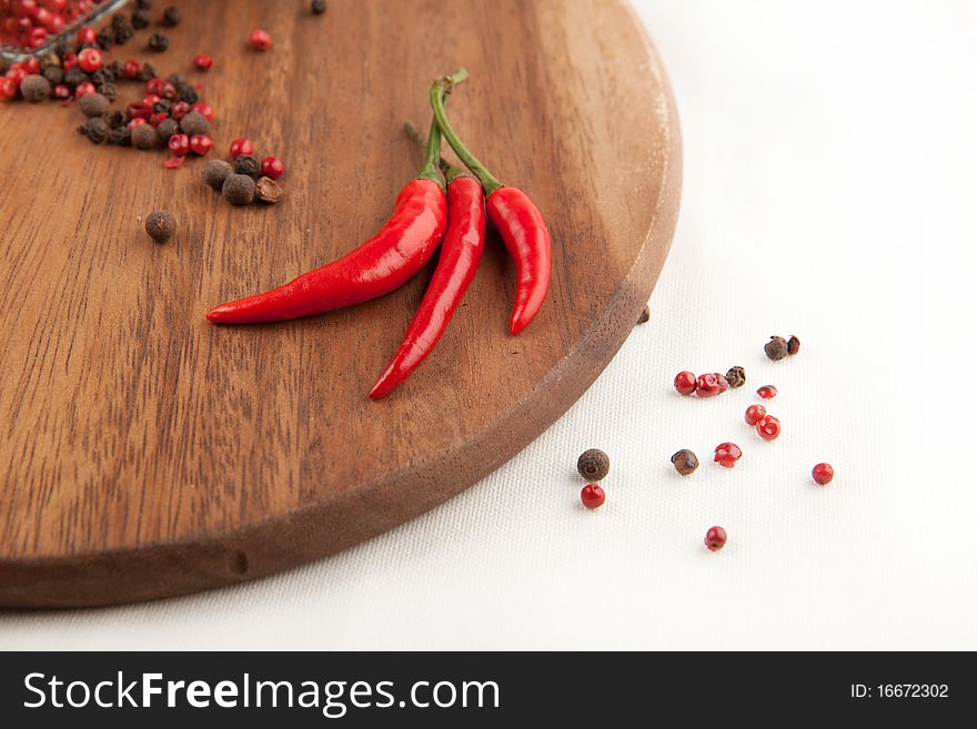 Red chili pepper and pepper's mix on the wooden desk