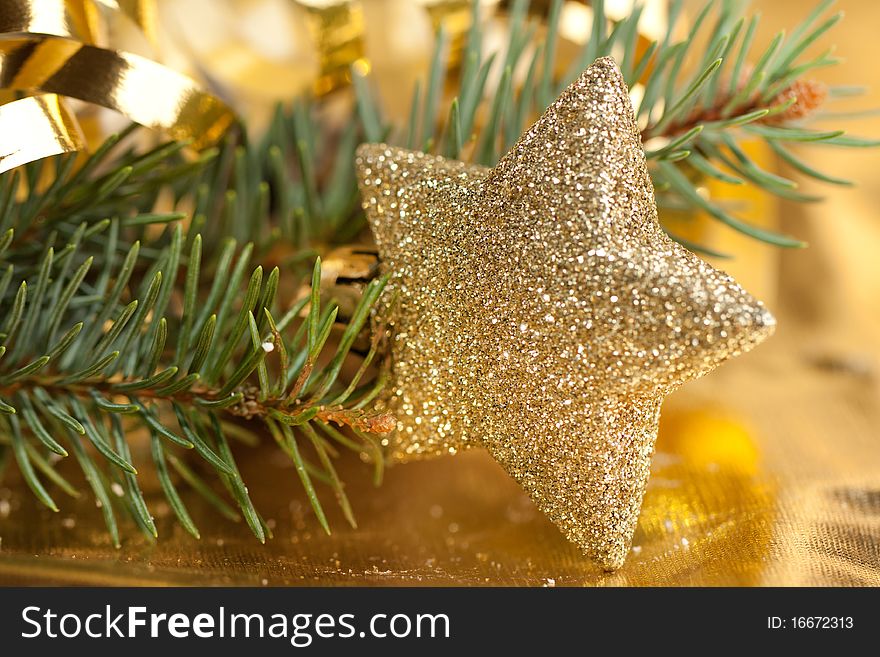 Golden christmas star with christmas tree on the gold background