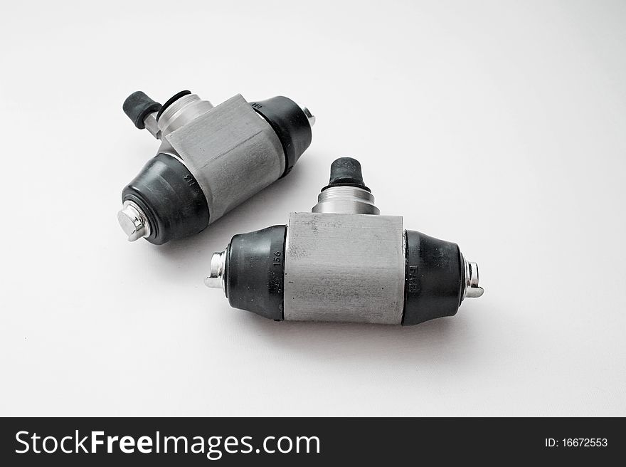 Pair of hydraulic brake cylinders on an isolated white background
