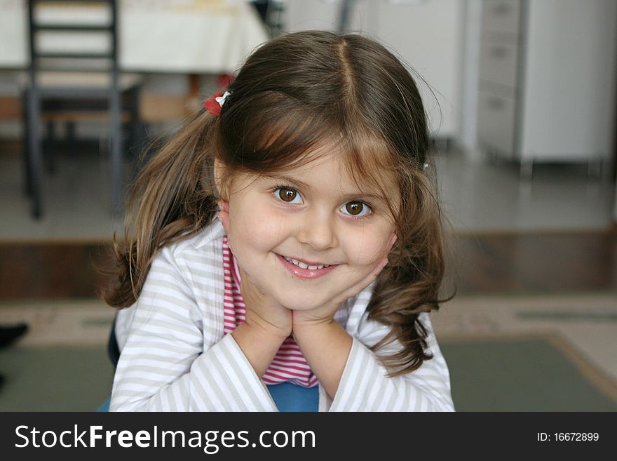 Little girl smiling with brown eyes