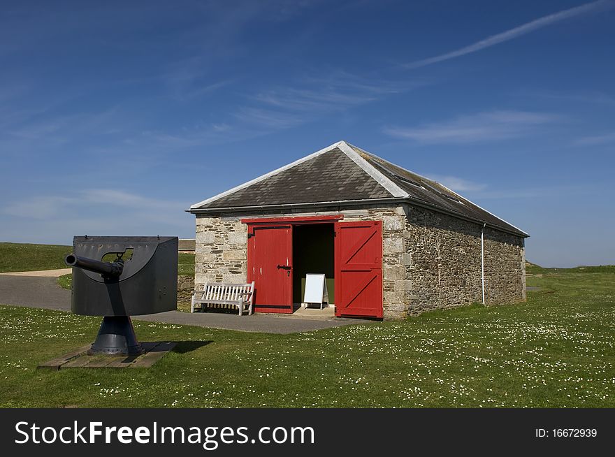 Storage unit with cannon under blue sky