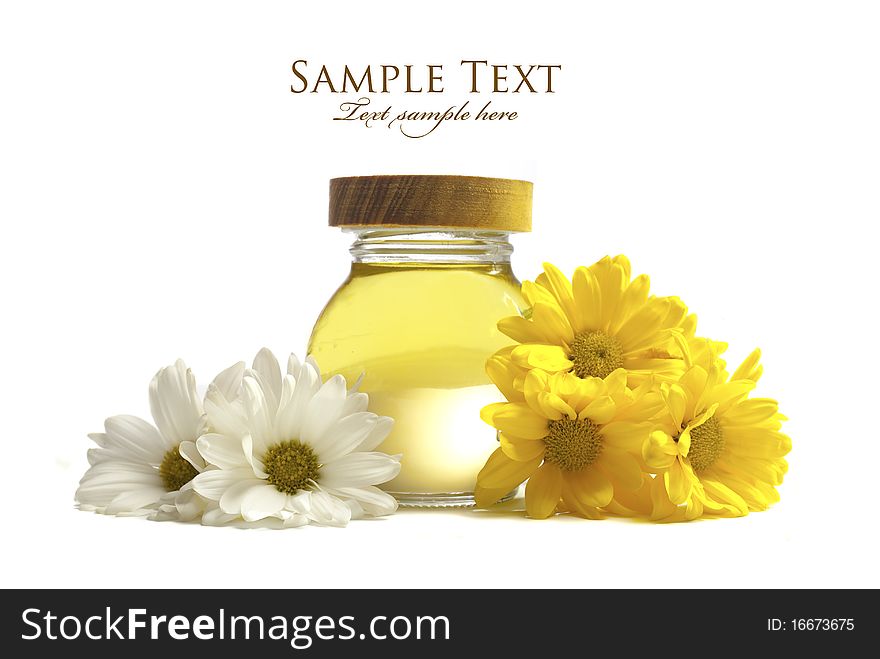 Oil and flowers isolated on white