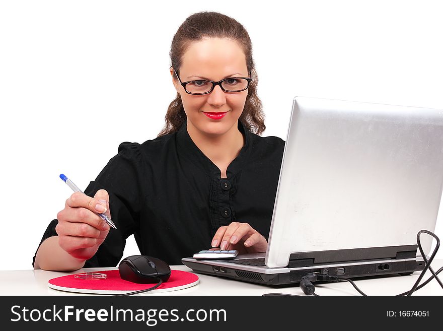 Businesswoman in glasses in office, working on a laptop. Businesswoman in glasses in office, working on a laptop