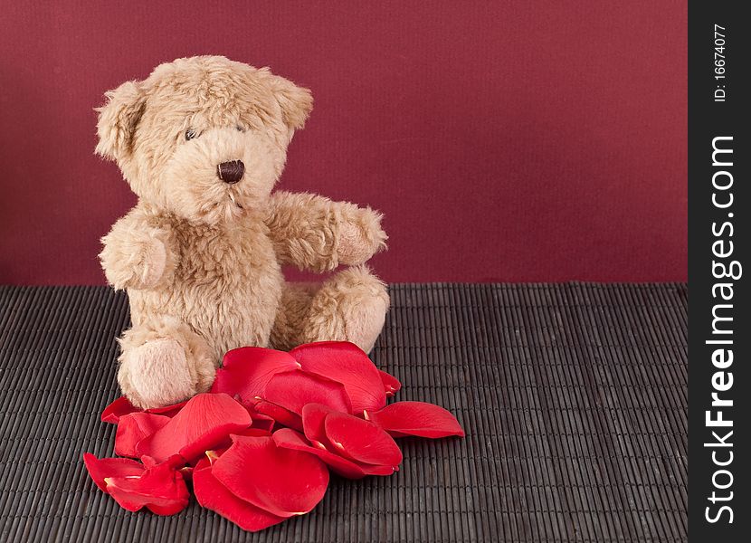 Brown Teddy Bear with Pile of Roses