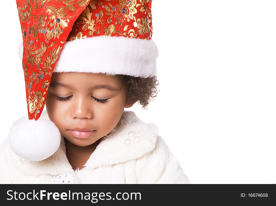 Portrait of a sweet baby in Christmas hat and fur on white background. Portrait of a sweet baby in Christmas hat and fur on white background