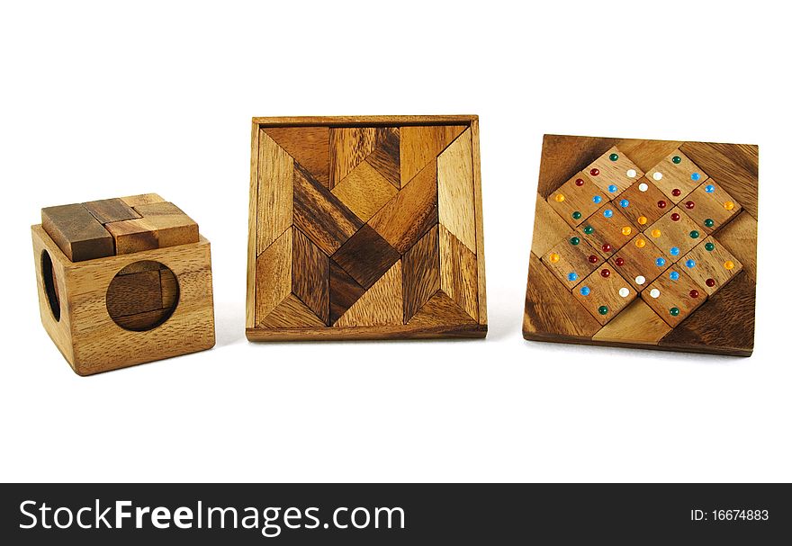 Three wooden puzzles isolated on white
