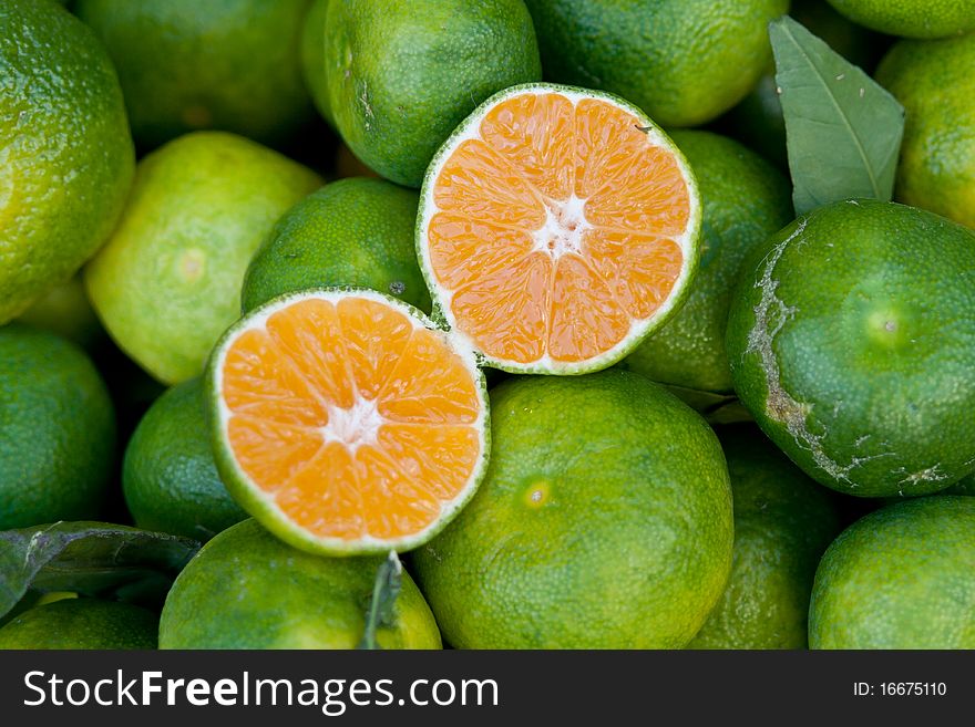 Green tangerines at a market place
