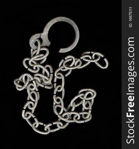 Old metallic chain isolated on the black background