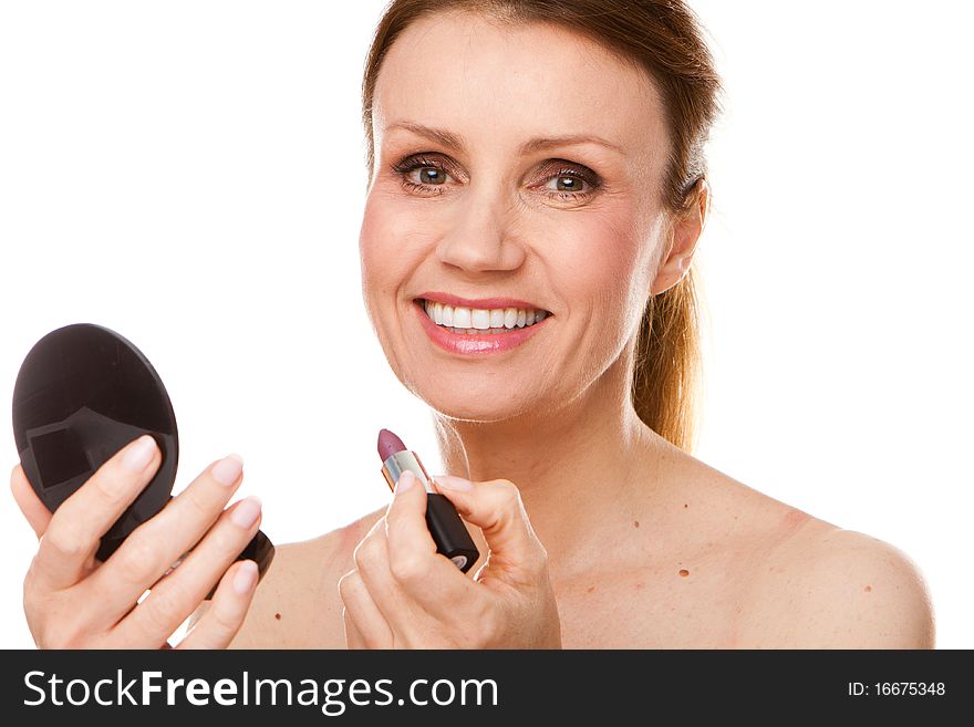 Early fourties woman applying mascara lipstick, white background. Early fourties woman applying mascara lipstick, white background