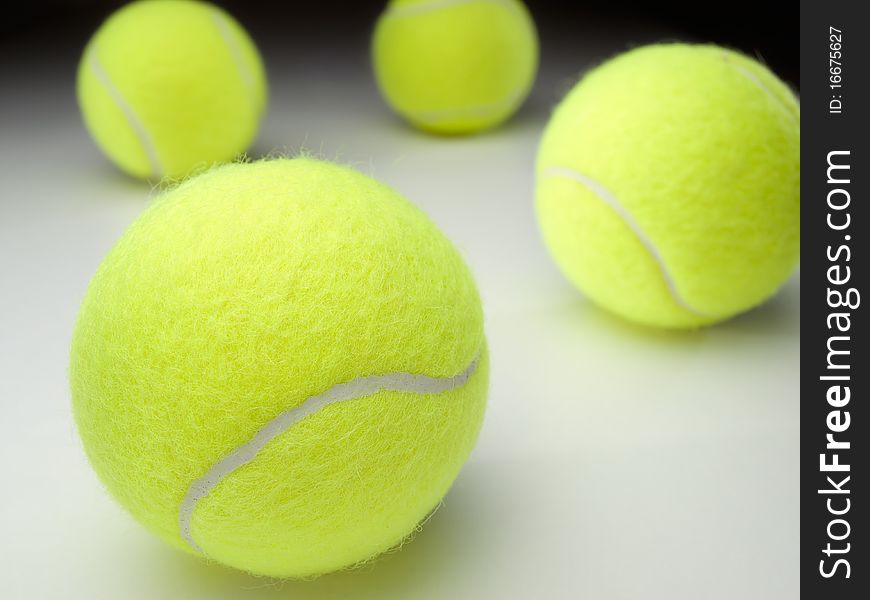 Tennis balls on white surface ,for various tennis,recreation and sport themes. Tennis balls on white surface ,for various tennis,recreation and sport themes