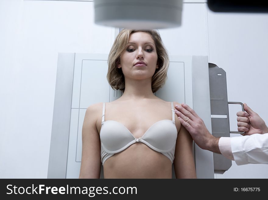 Young woman receiving x-ray scan. Young woman receiving x-ray scan